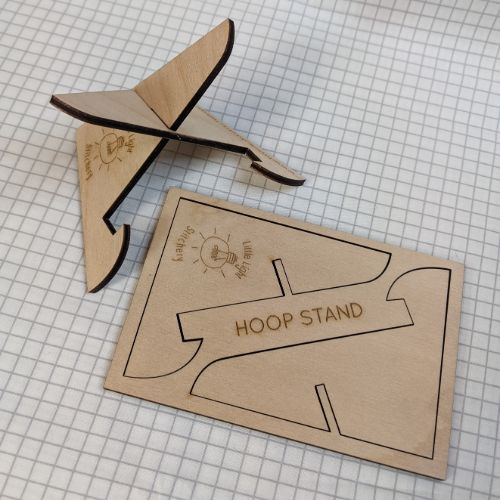 Flatpack postcard and constructed empty hoop stand
