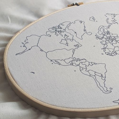World map fabric printed on calico ina simple oval wooden embroidery hoop