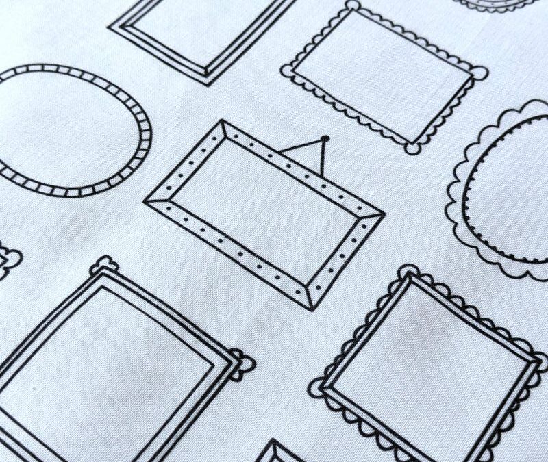 WHite fabric with the outlines of simple picture frames printed on it